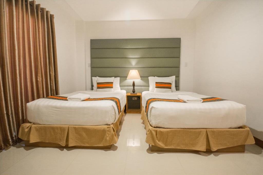 Postel nebo postele na pokoji v ubytování Sur Beach Resort Boracay