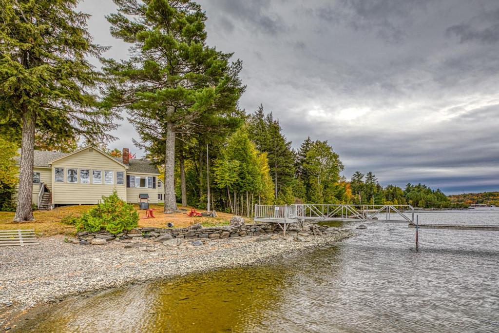 a house on the shore of a body of water at White Lobster Cottage in Greenville