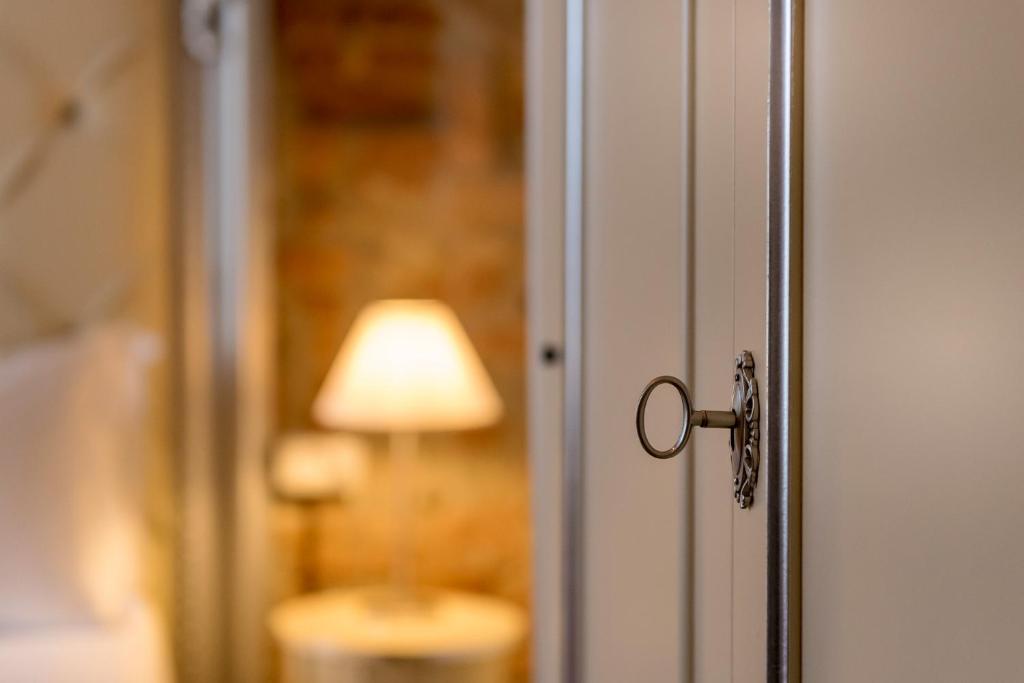 a close up of a door with a lamp in the background at Residenza Conte di Cavour & Rooftop in Florence