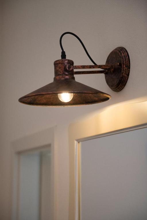 an old lamp hanging from the ceiling in a room at Residenza Conte di Cavour & Rooftop in Florence
