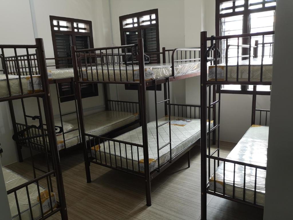 a group of bunk beds in a room at Homey Hostel in Ipoh