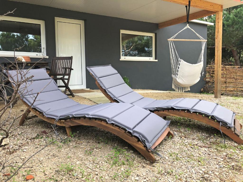 a group of chairs in a backyard with a hammock at Quinta do Meco - Beach & Nature in Aldeia do Meco