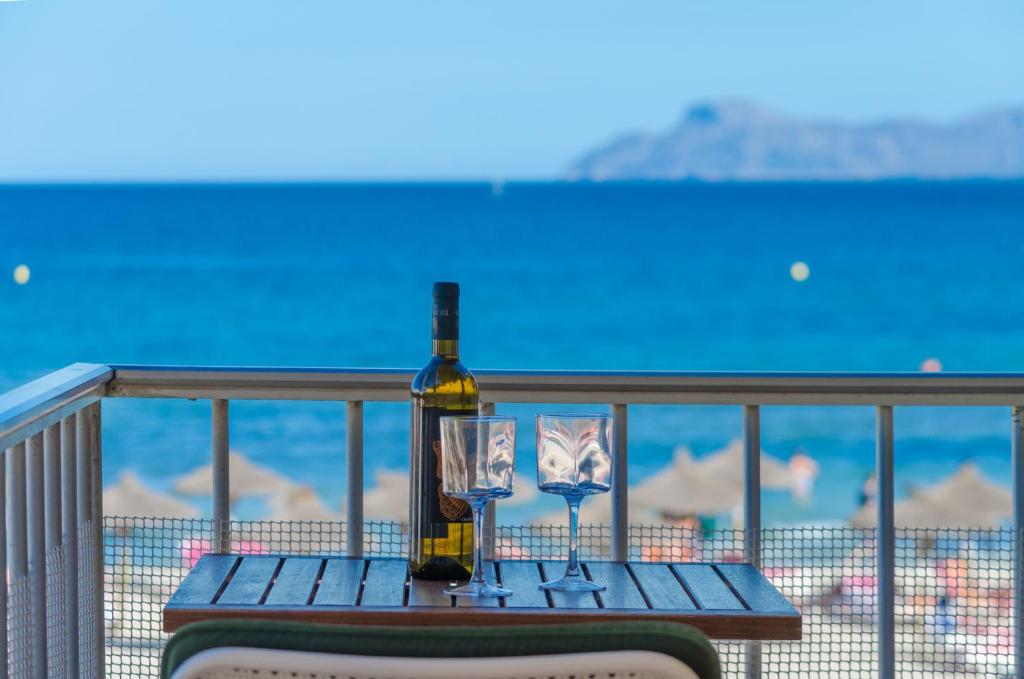 a bottle of wine sitting on a table on a balcony at Can Vesses in Alcudia
