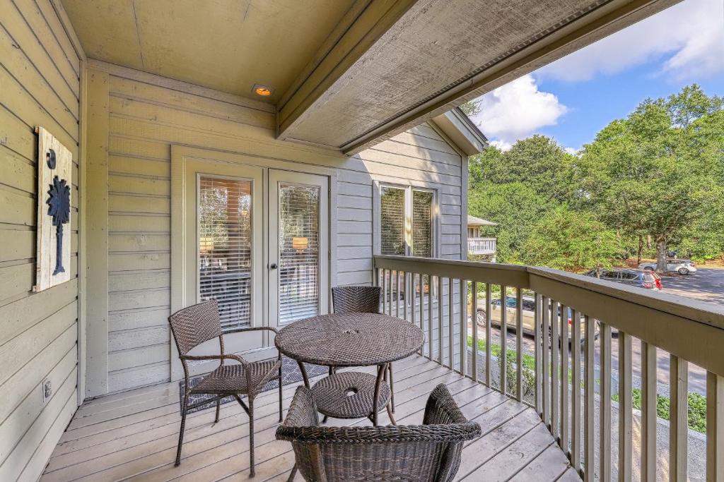 a patio with a table and chairs on a porch at St Andrews Common in Hilton Head Island