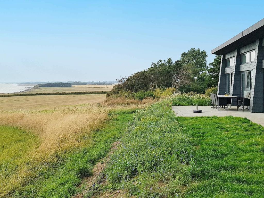 una casa con una mesa junto a un campo en 8 person holiday home in Kalundborg, en Kalundborg