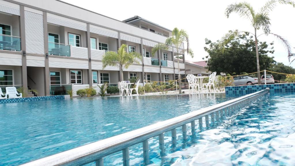 a large swimming pool in front of a building at Aneeda Inn in Pantai Cenang