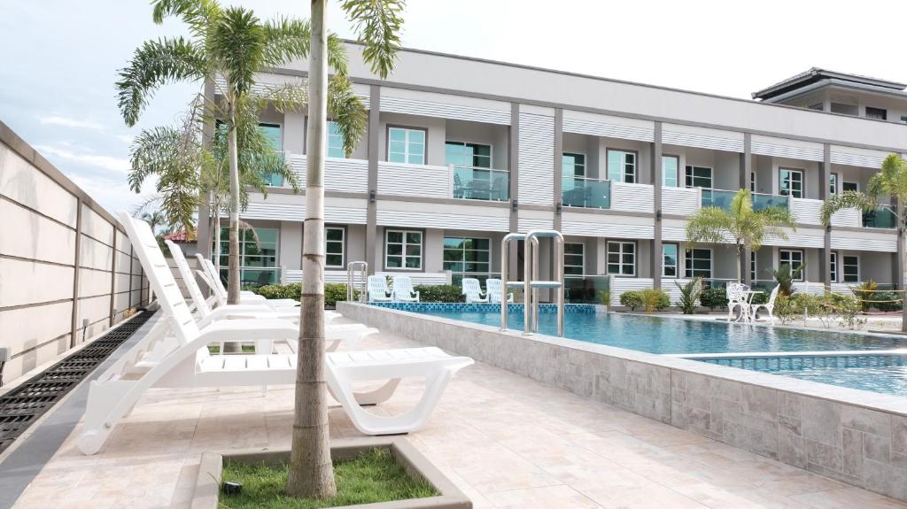 an exterior view of a building with a swimming pool at Aneeda Inn in Pantai Cenang