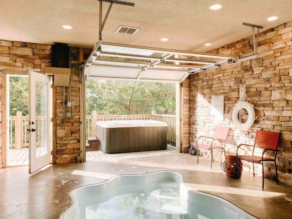 a room with a bath tub in the middle of a room at Mountain Splash -heated indoor pool, hot tub, arcade game room in Pigeon Forge