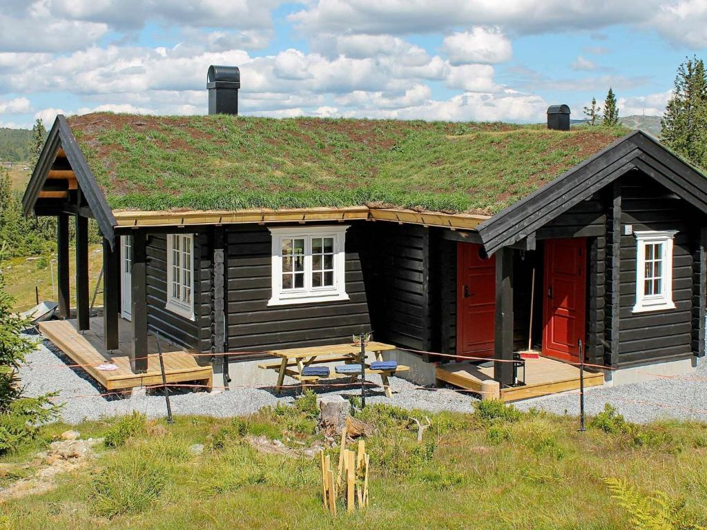 a small log cabin with a grass roof at 6 person holiday home in Svingvoll in Svingvoll