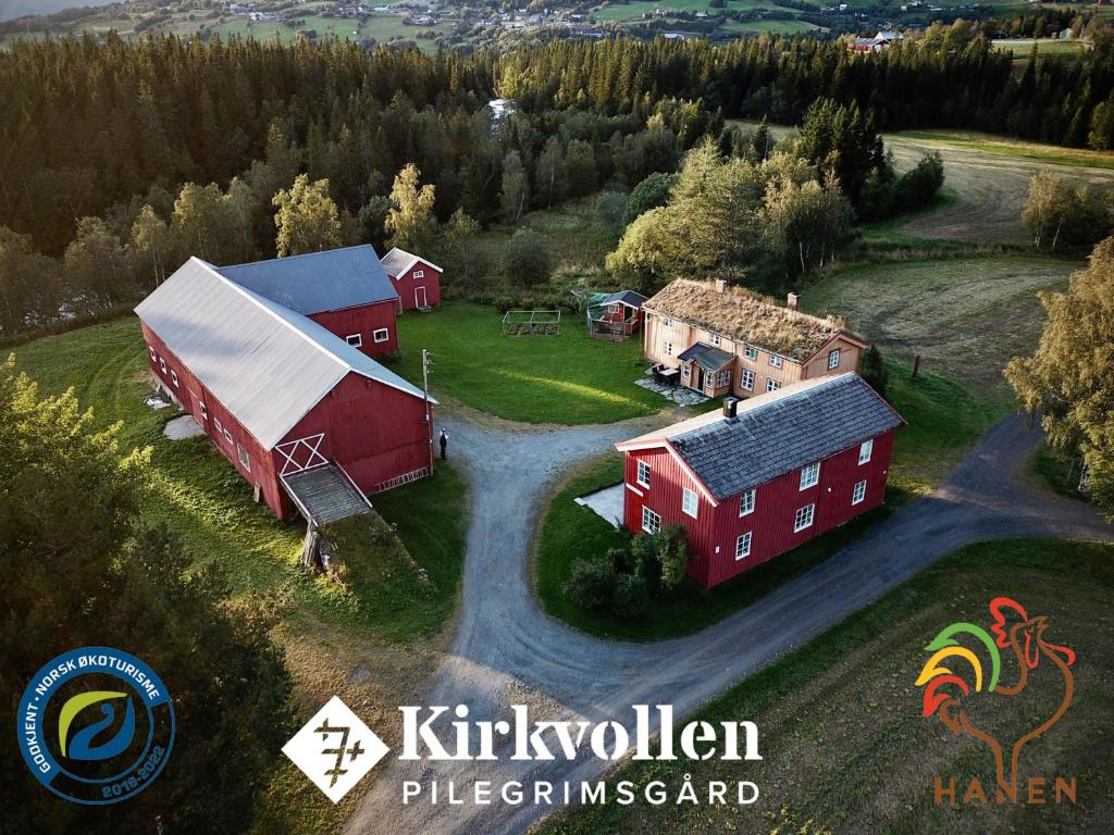 an aerial view of a farm with a red barn at Kirkvollen pilegrimsgård in Tydal