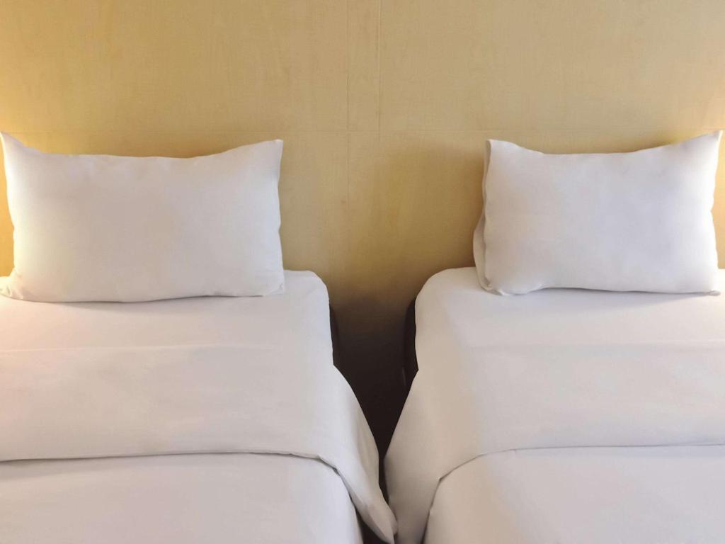 Postel nebo postele na pokoji v ubytování Ibis Padang