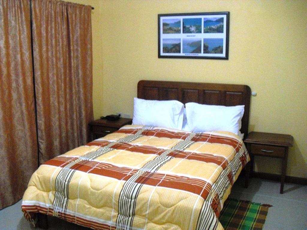 Postel nebo postele na pokoji v ubytování Piarco Village Suites