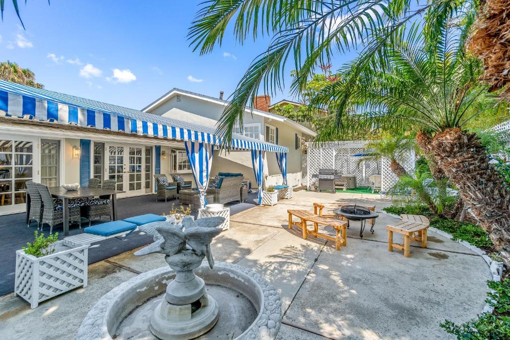 a house with a fountain in the middle of a yard at By The Sea in San Diego