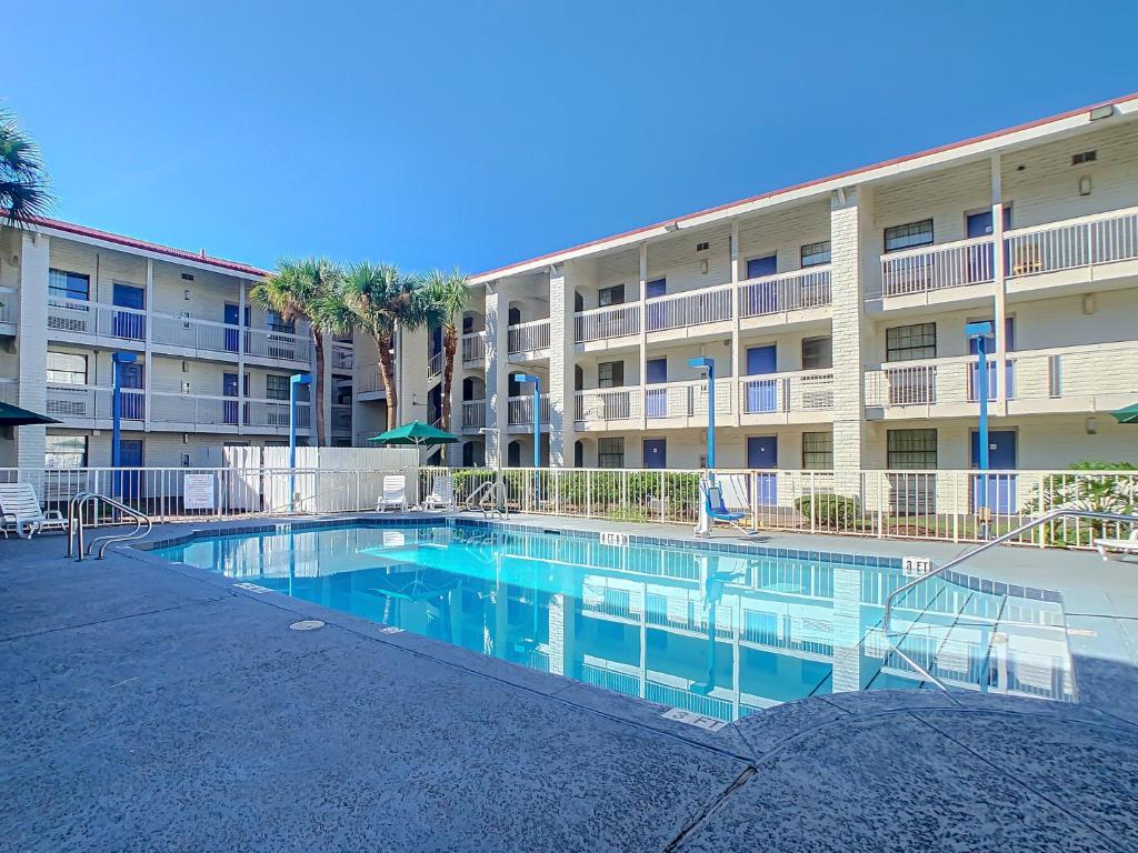 a swimming pool in front of a apartment building at Stayable Jacksonville North in Jacksonville