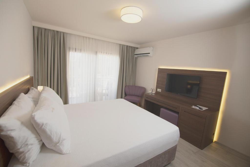 Postel nebo postele na pokoji v ubytování Neopol Hotel