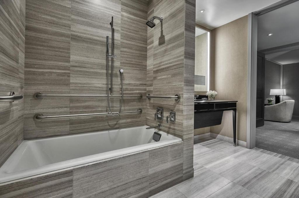 a bathroom with a tub and a sink at Four Seasons Hotel One Dalton Street, Boston in Boston