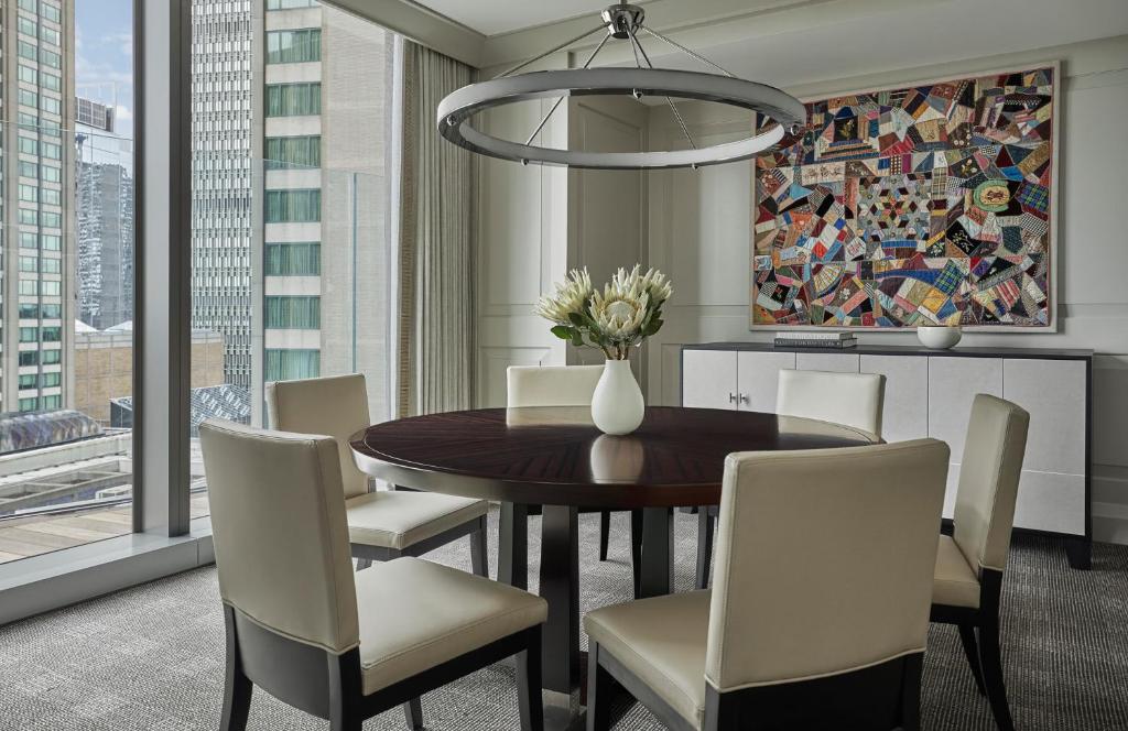 a dining room with a table and chairs at Four Seasons Hotel One Dalton Street, Boston in Boston