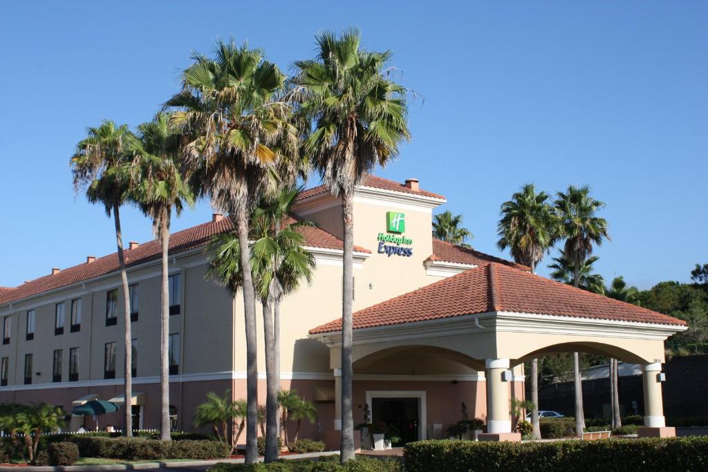 a hotel with palm trees in front of it at Holiday Inn Express - Clermont, an IHG Hotel in Clermont