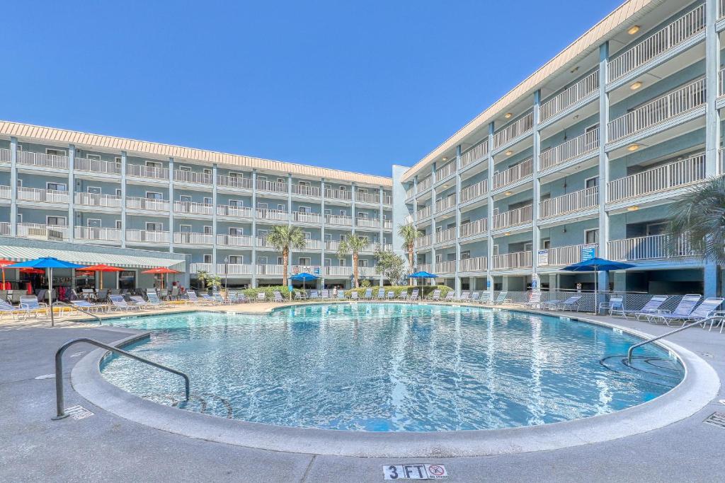 a large swimming pool in front of a hotel at Hilton Head Resort in Hilton Head Island