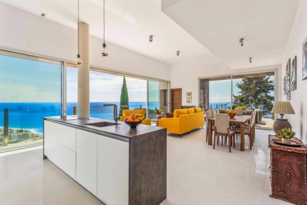 a kitchen and living room with a view of the ocean at Villa Tierra in Nerja