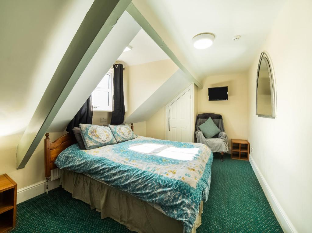 a bedroom with a bed in a attic at Hotel 119 in Darlington