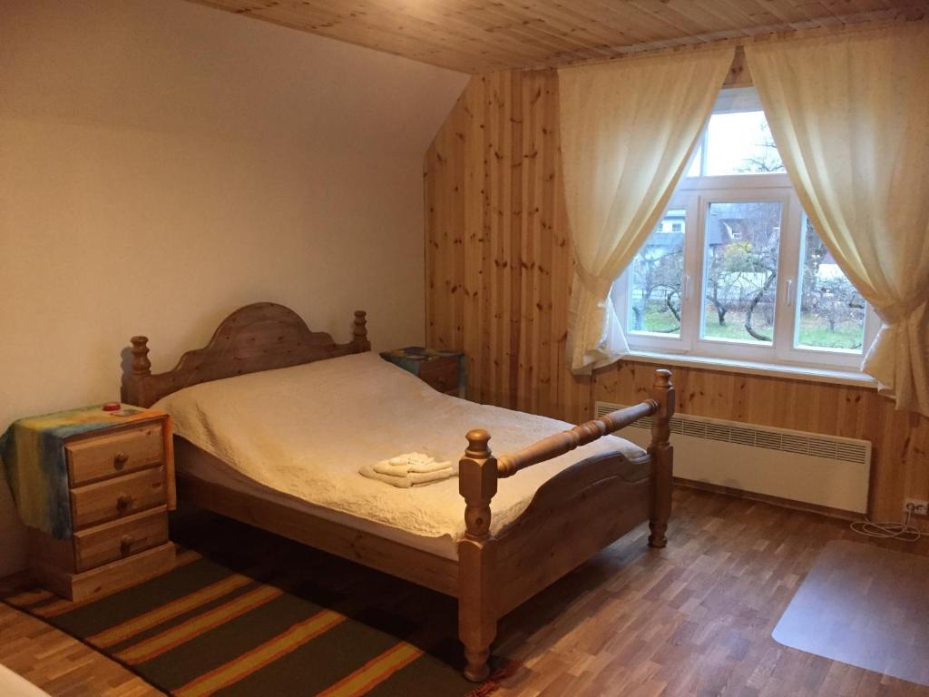a bedroom with a bed and a window at Angelhouse studio in Tartu