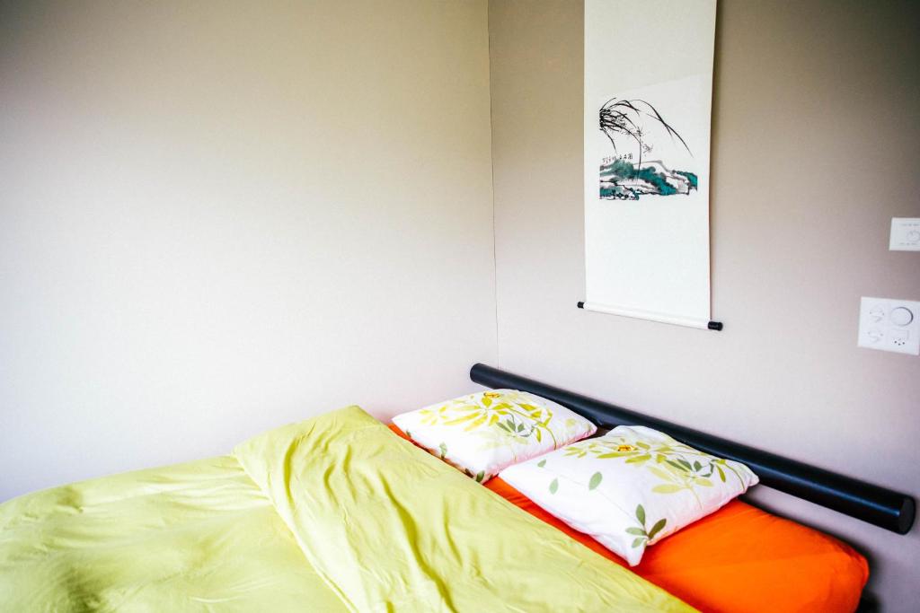 a bed in a room with two pillows on it at Luxury loft on top of Villa Wilen with tremendous views by the lake in Sarnen