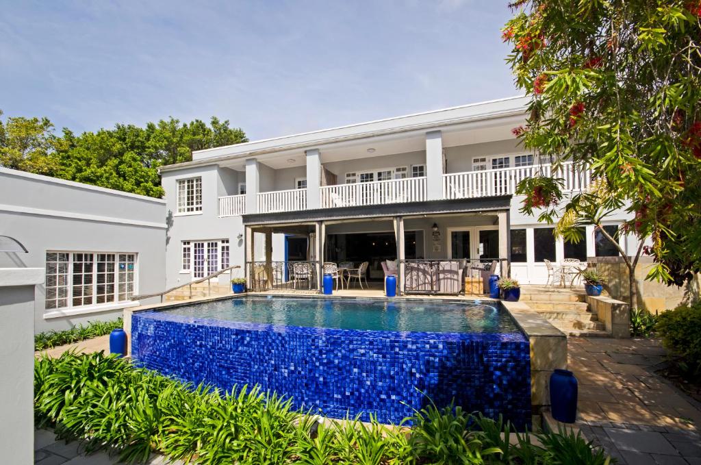 an exterior view of a house with a swimming pool at Lodge on Main Guest House and Conference Centre in Port Elizabeth