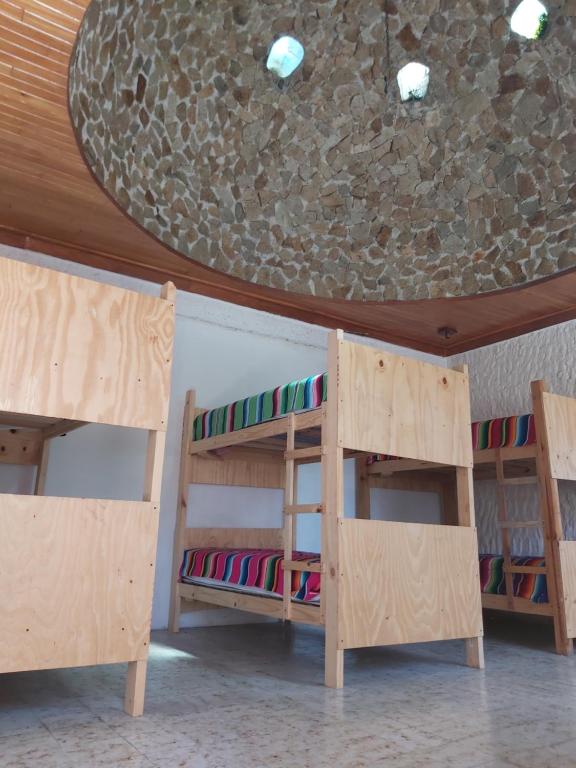 two bunk beds in a room with a ceiling at El Sunset Hostel in Puerto Vallarta
