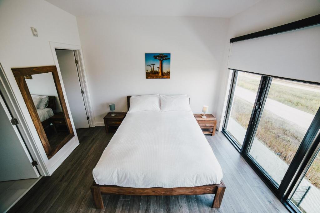 a bedroom with a bed and a large window at LXTX Luxury Apartments by Corporate Stays in Winnipeg