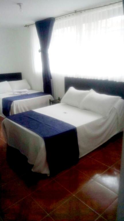 Postel nebo postele na pokoji v ubytování Hotel Casa Guillermo