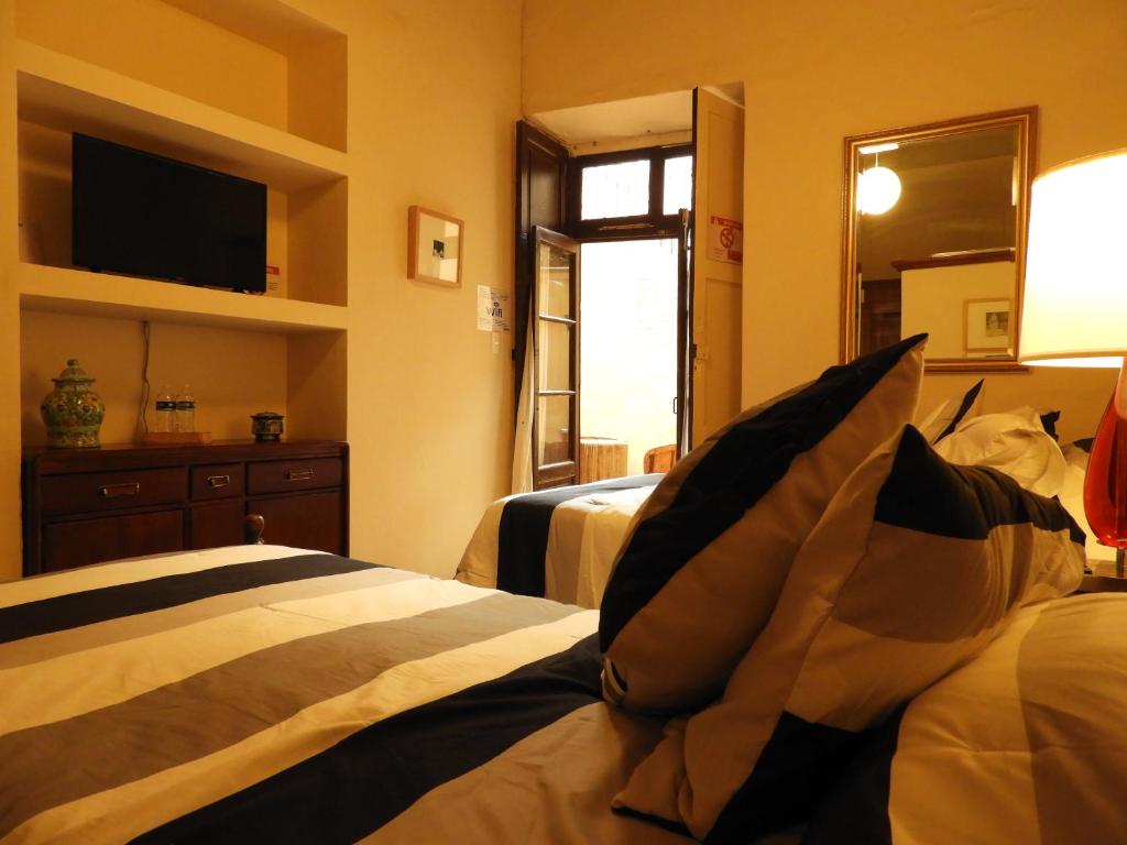 Postel nebo postele na pokoji v ubytování El Viejo Zaguan by Lunian