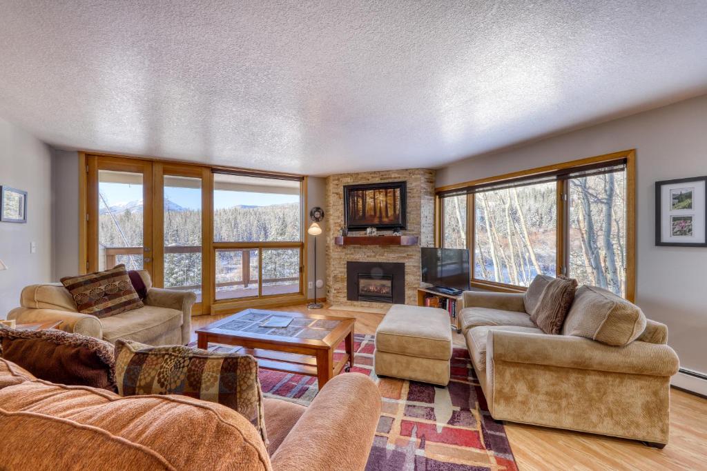 a living room with couches and a fireplace at Watch Hill 216 in Silverthorne