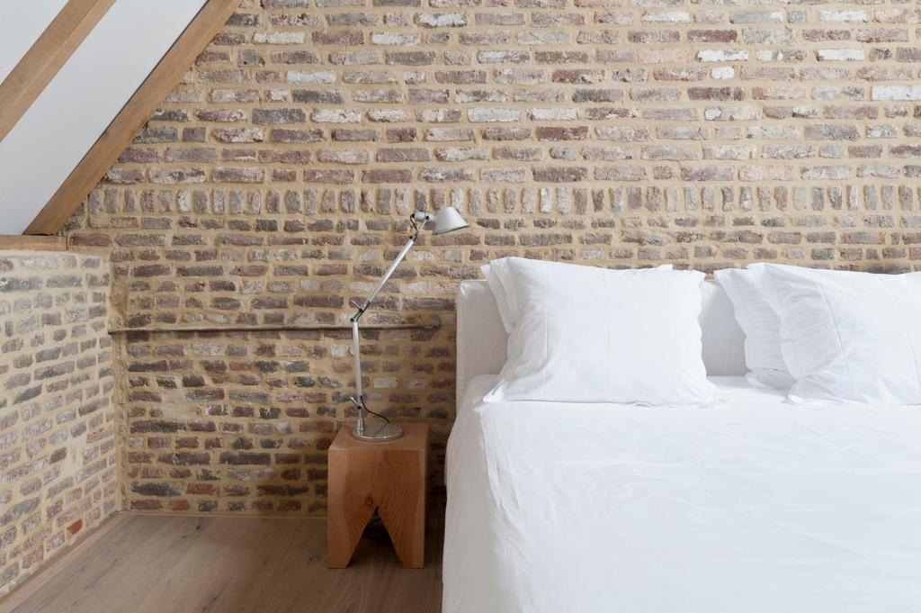 Postel nebo postele na pokoji v ubytování Cour 8 Lofts