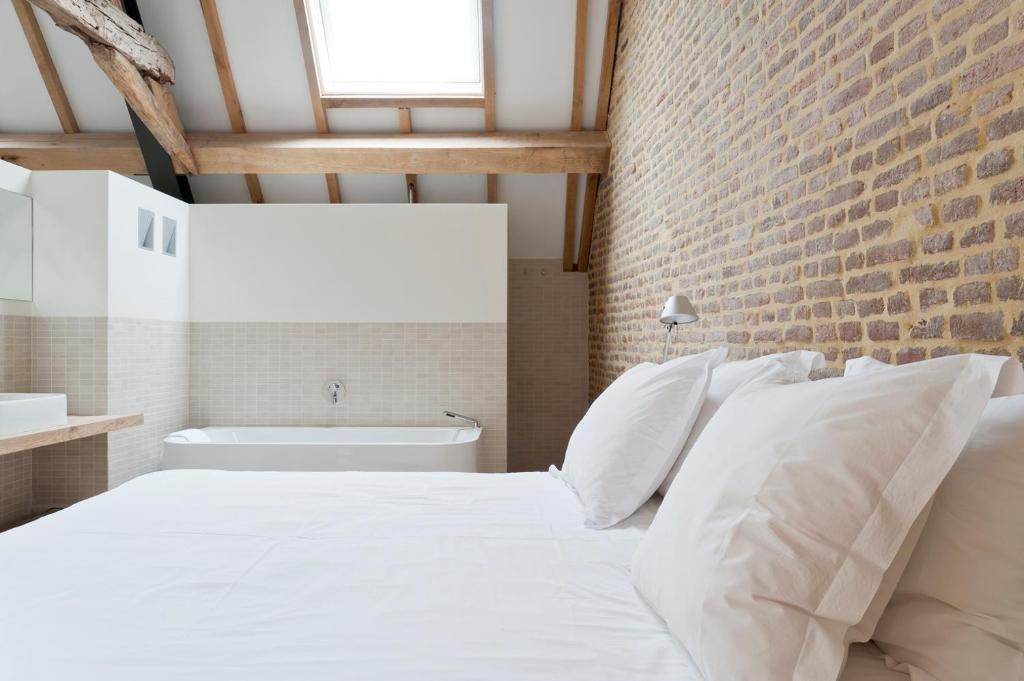 Postel nebo postele na pokoji v ubytování Cour 8 Lofts