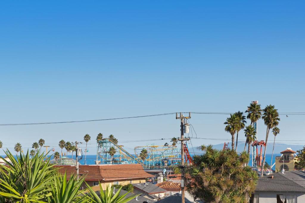 a roller coaster at a theme park with palm trees at Boardwalk Dream in Santa Cruz