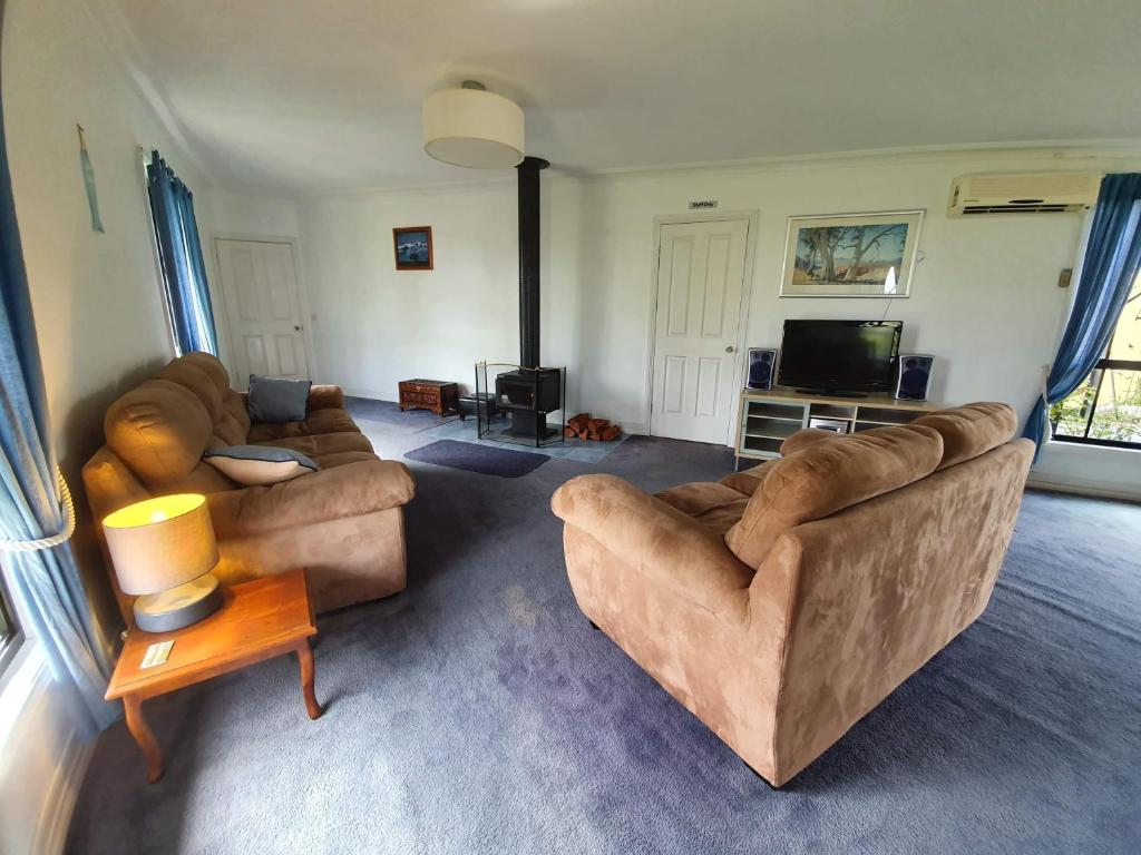 a living room with two couches and a television at Chateau Bass in Bass