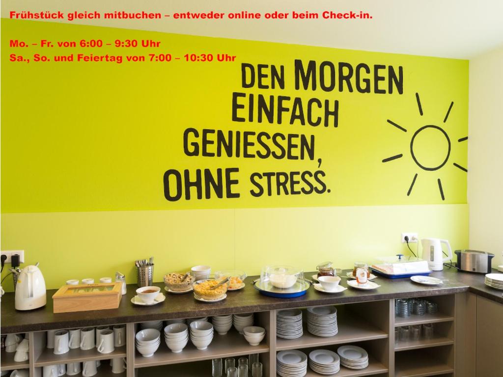 a yellow wall with a sign on it in a kitchen at Smart Motel in Gars am Kamp