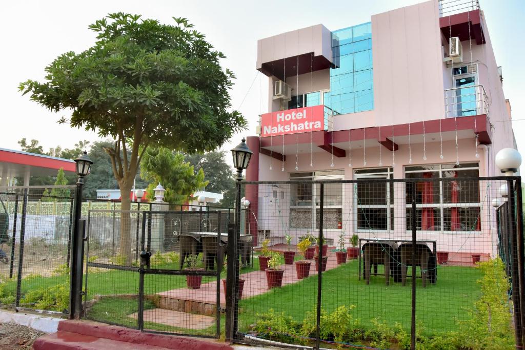 a building with a fence in front of it at Hotel Nakshatra in Sawāi Mādhopur