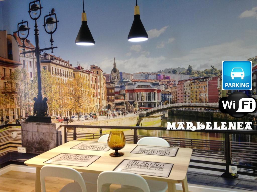 a table with chairs and a view of a city at Markelenea - Bilbao – Casco Viejo – Parking – WIFI Gratis in Bilbao