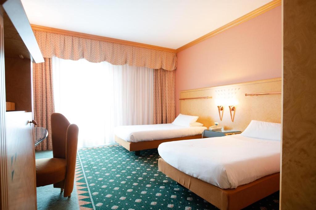 Postel nebo postele na pokoji v ubytování SHG Hotel Antonella