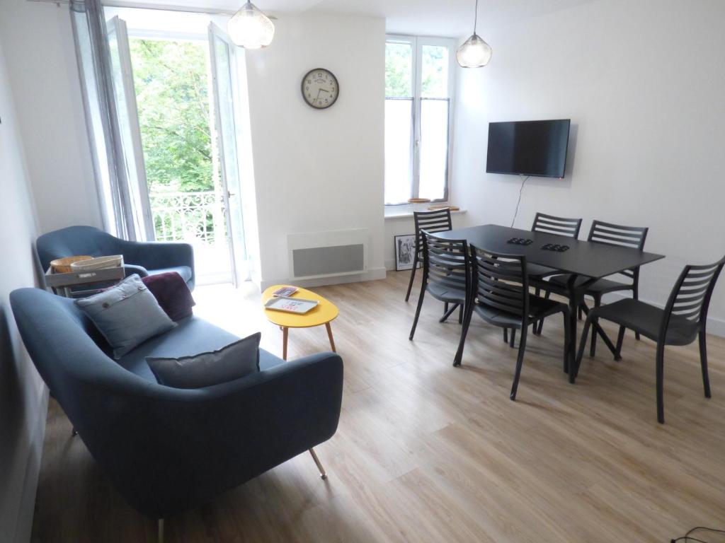 a living room with a table and chairs and a dining room at Luz et vous , T 3, classé 2 étoiles in Luz-Saint-Sauveur