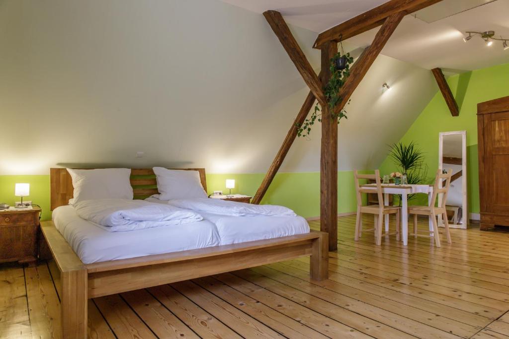 a bedroom with a bed in a room with green walls at SchlafGut Gmelin in Angelbachtal