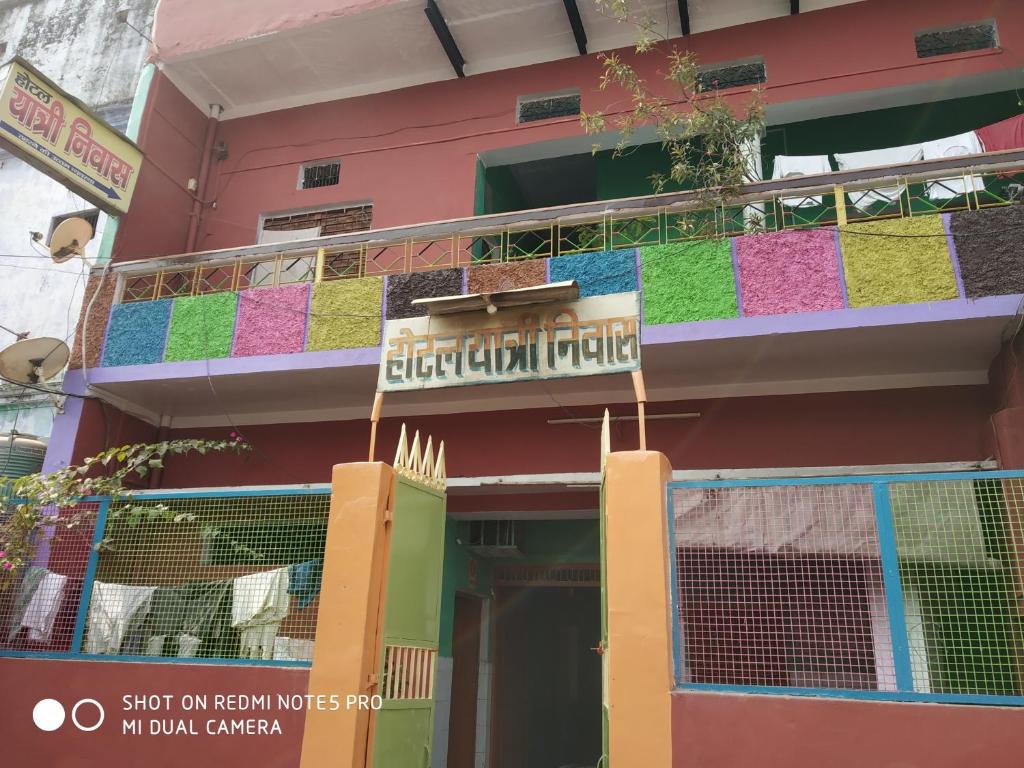 a colorful building with a balcony with a sign on it at Hotel Yatri Niwas in Varanasi