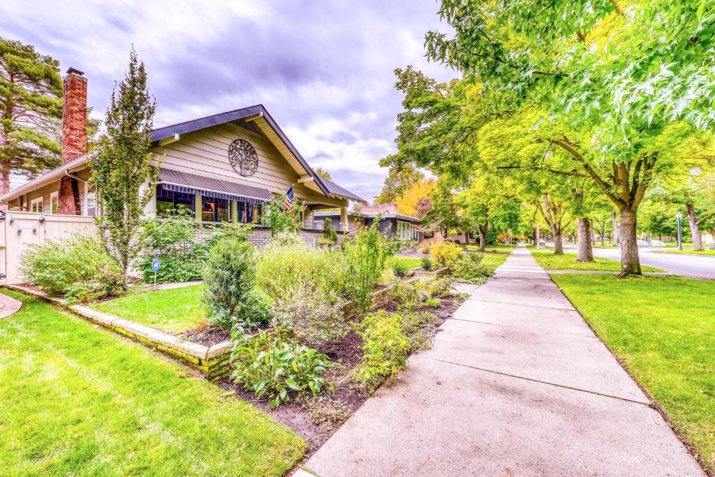 a house with a sidewalk in front of a yard at The Harrison House in Boise