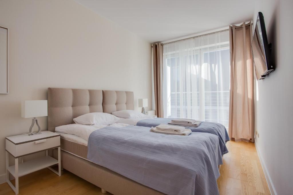 Postel nebo postele na pokoji v ubytování Apartamenty Tulipan - visitopl