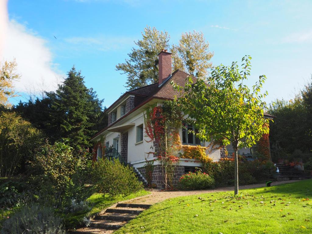 a white house with a tree in the yard at Cour Tholmer in Touques