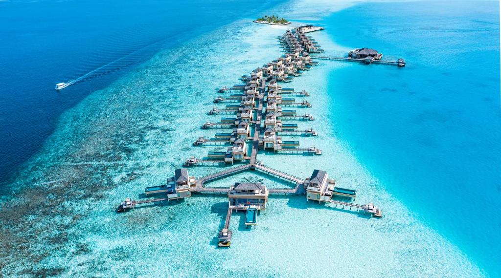 an aerial view of an island in the ocean at Angsana Velavaru In-Ocean Villas - All Inclusive SELECT - Limited time offer Book 3 Nights and get 2 additional Nights Complimentary extension stay in Beachfront Villa with Half Board Meal Plan in Dhaalu Atoll