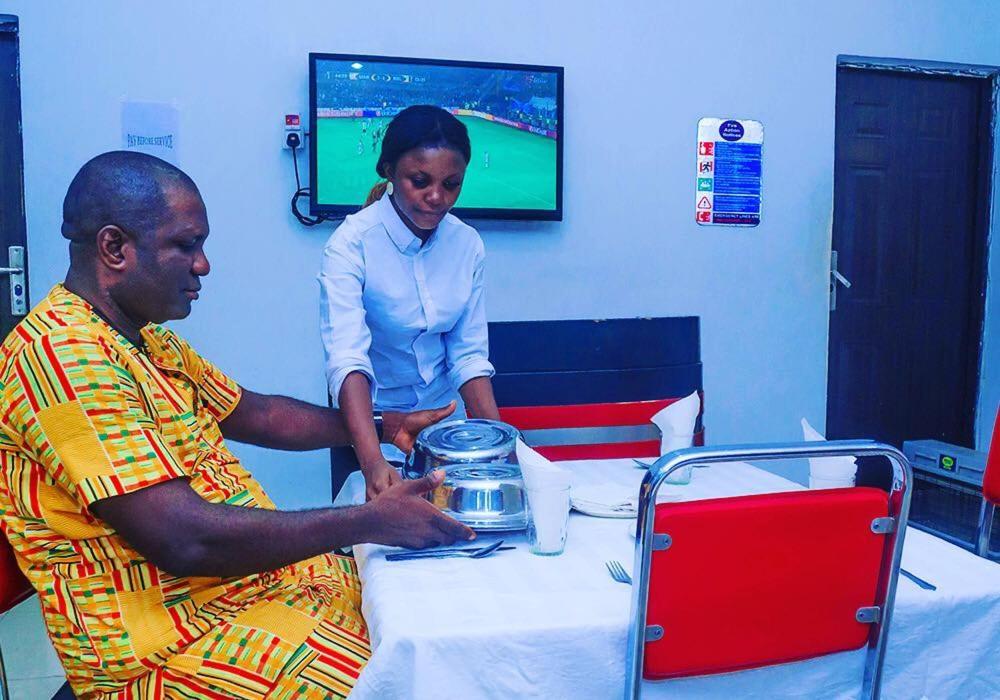 a woman standing next to a man in a hospital room at World Class Hotel & Apartments in Abuja