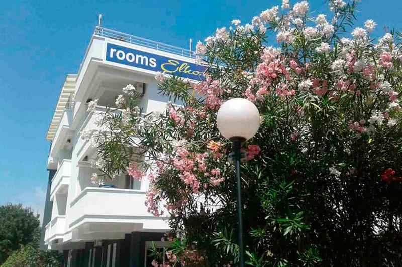 a building with a street light in front of a tree at 500 Meters from Grate Beach, App 9 in Ulcinj